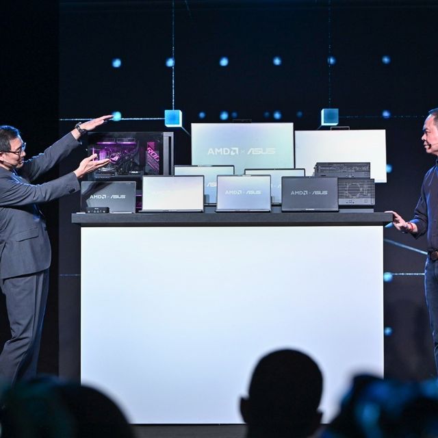 ASUS Co-CEO S.Y. Hsu (left) shows Jack Huynh, AMD Senior Vice President and General Manager of the Computing and Graphics Group, some of ASUS's commercial products at the AMD press conference during Computex.